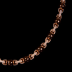 Collier perlé rose gold porté par un homme avec boucles d’oreilles, style tendance et moderne